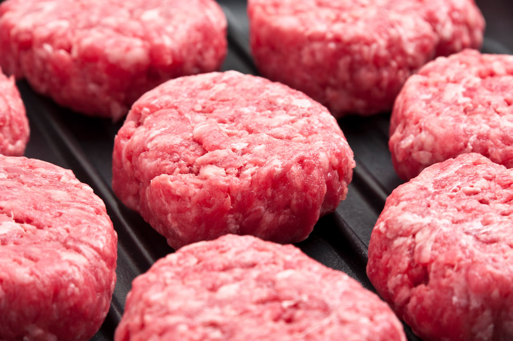 Småhamburgare som ligger på en grill